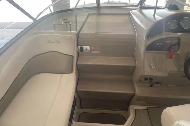 Slide: The Image of 2006 Sea Ray Sundancer 260 interior with helm, seating, and control panel. - 13