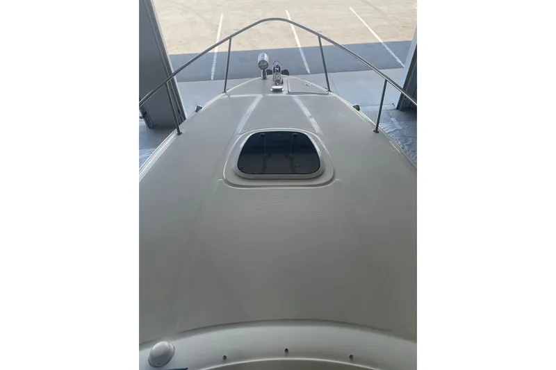 Slide: The Image of 2006 Sea Ray Sundancer 260 boat deck with hatch, docked in a marina. - 14