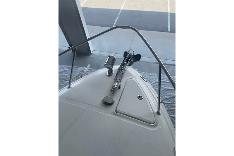 Slide: The Image of 2006 Sea Ray Sundancer 260 bow view with anchor and railing in a garage. - 15