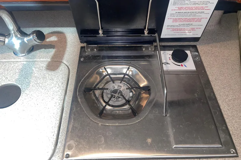 Slide: The Image of Stainless steel stove and sink in 2006 Sea Ray Sundancer 260 boat kitchen. - 19