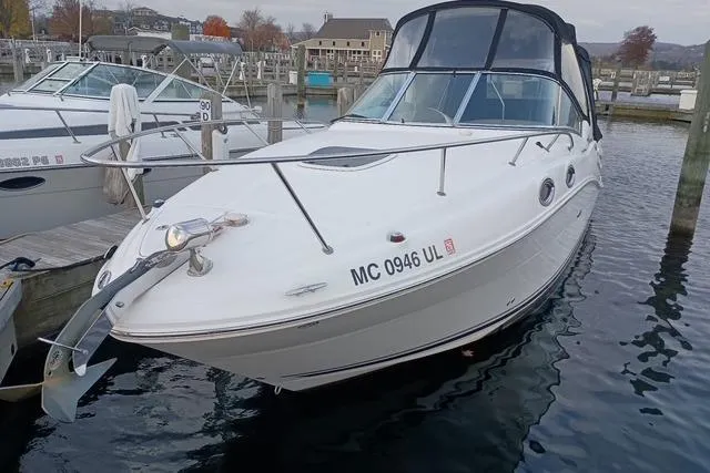 Slide: The Image of 2006 Sea Ray Sundancer 260 boat docked in marina, front view. - 2