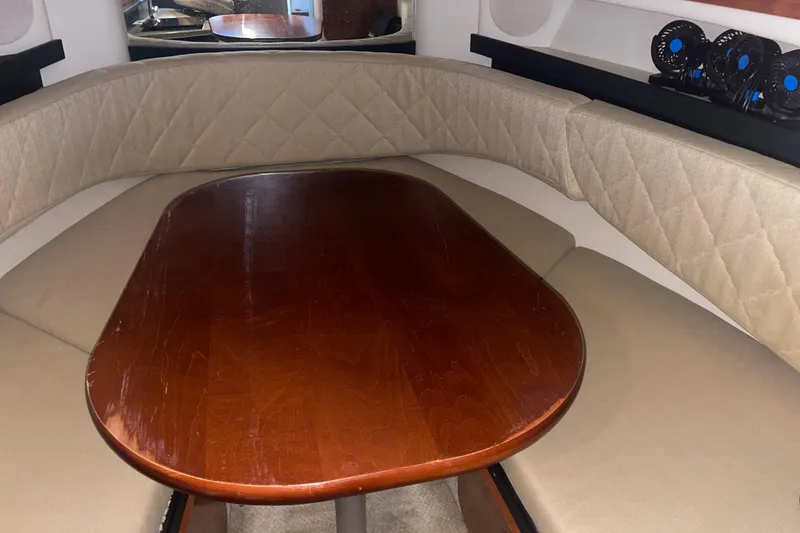 Slide: The Image of Interior cabin of 2006 Sea Ray Sundancer 260 with wooden table and cushioned seating. - 23
