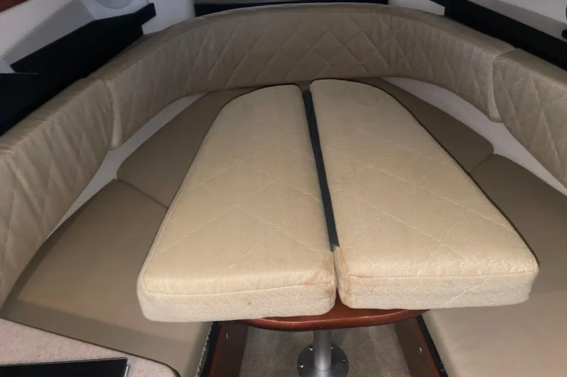 Slide: The Image of 2006 Sea Ray Sundancer 260 cabin interior with beige cushioned seating. - 24