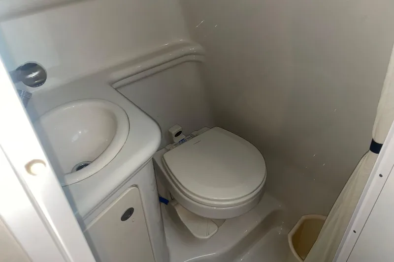 Slide: The Image of Compact bathroom in 2006 Sea Ray Sundancer 260 boat, featuring toilet and sink. - 25