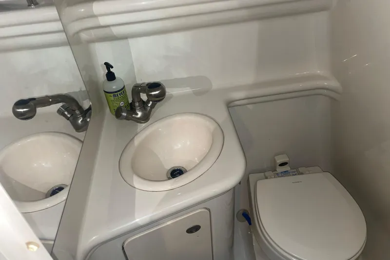 Slide: The Image of Compact bathroom in 2006 Sea Ray Sundancer 260 boat with sink and toilet. - 26