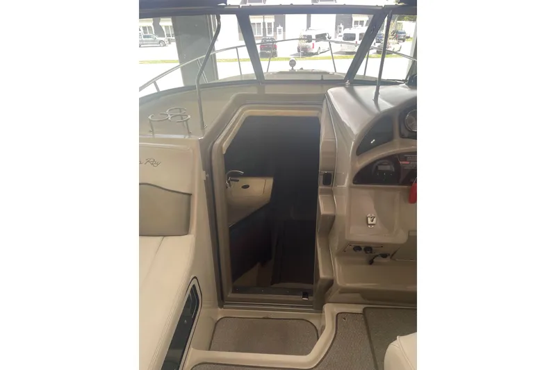 Slide: The Image of 2006 Sea Ray Sundancer 260 cabin entrance with dashboard and seating area. - 27
