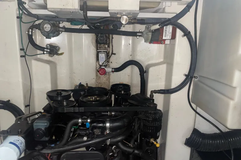 Slide: The Image of Engine compartment of a 2006 Sea Ray Sundancer 260 boat, showcasing mechanical components. - 29