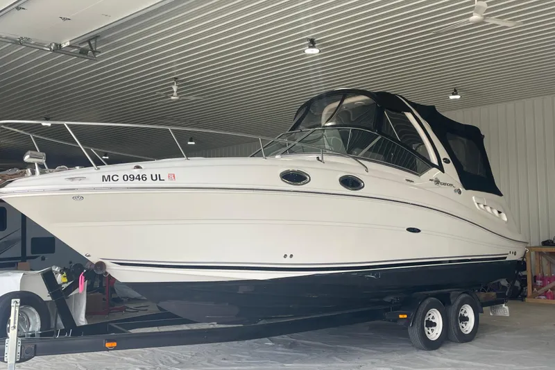 Slide: The Image of 2006 Sea Ray Sundancer 260 boat on trailer in indoor storage facility. - 3