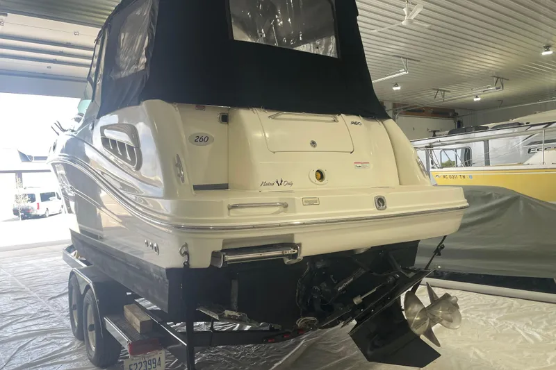 Slide: The Image of 2006 Sea Ray Sundancer 260 boat in indoor storage on a trailer. - 5