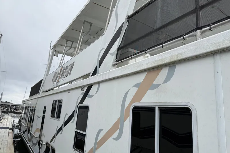 The Image of 2001 Sharpe 80 X 18 houseboat docked, featuring modern design and spacious upper deck. - 1