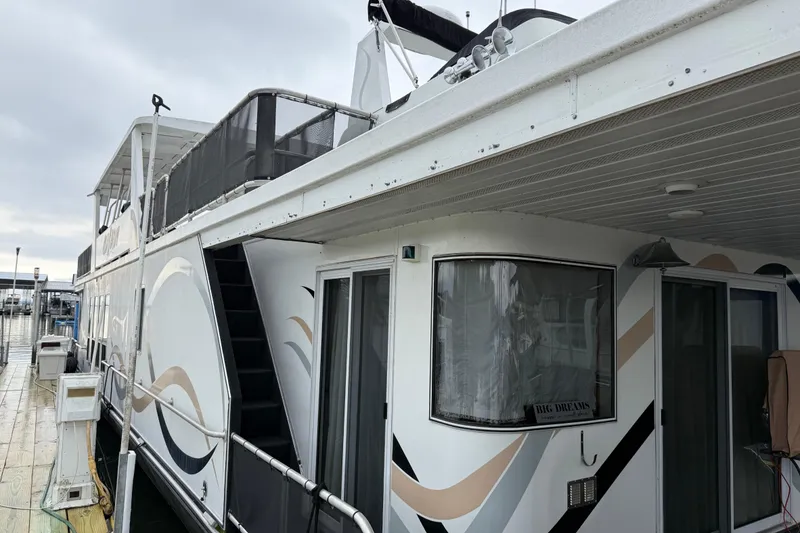 Slide: The Image of Houseboat docked at marina, Sharpe 80 X 18 model, 2001, with modern design elements. - 10