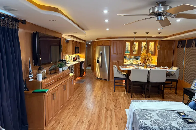 Slide: The Image of Luxurious interior of a 2001 Sharpe 80 X 18 houseboat with modern kitchen and dining area. - 100