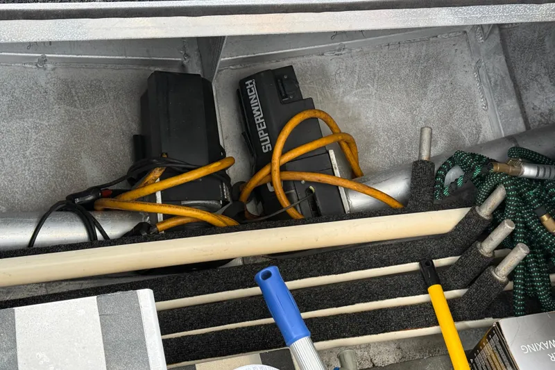 Slide: The Image of Storage compartment with Superwinch, cables, and tools in a 2001 Sharpe 80 X 18. - 101