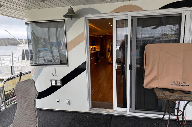 Slide: The Image of Houseboat deck with sliding glass door, covered grill, and lake view. Sharpe 80 X 18, 2001 model. - 103