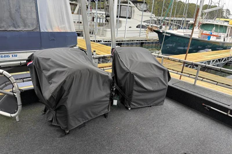 Slide: The Image of Covered engines on a 2001 Sharpe 80 X 18 houseboat at a marina. - 107