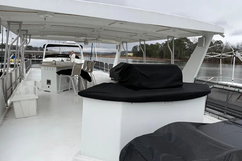 Slide: The Image of Upper deck of 2001 Sharpe 80 X 18 houseboat with covered seating and bar area. - 111