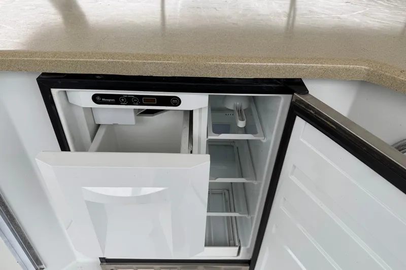 Slide: The Image of Open refrigerator with ice maker under a beige countertop, Sharpe 80 X 18, 2001 model. - 123
