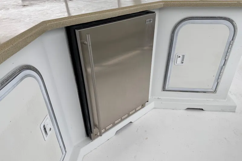 Slide: The Image of Stainless steel fridge and storage compartments on 2001 Sharpe 80 X 18 boat. - 124