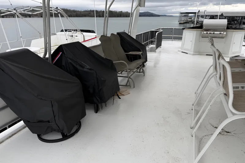 Slide: The Image of Upper deck of 2001 Sharpe 80 X 18 houseboat with covered chairs and grill. - 126