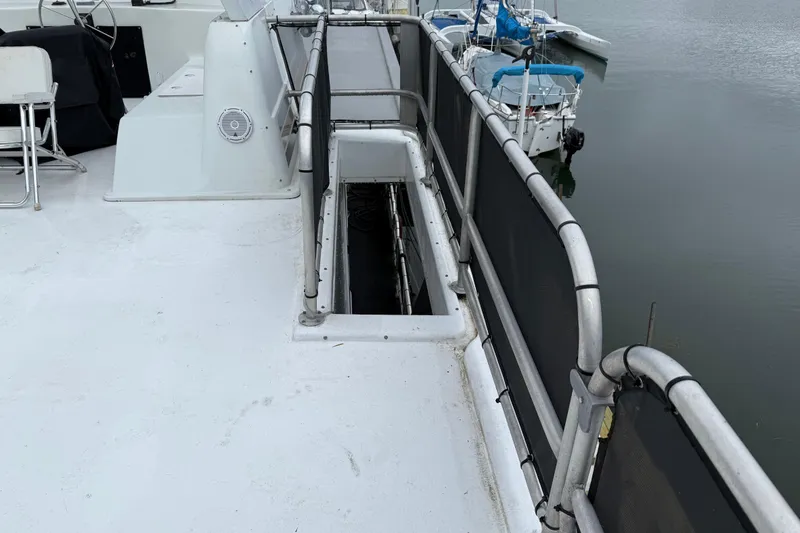 Slide: The Image of 2001 Sharpe 80 X 18 boat deck with railing and open hatch. - 127