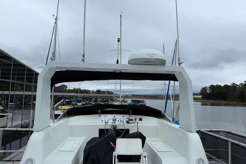 Slide: The Image of Houseboat docked at marina, cloudy sky, Sharpe 80 X 18, 2001 model. - 128