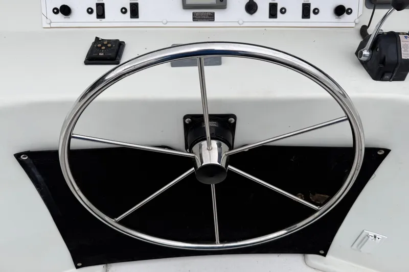 Slide: The Image of Steering wheel of a 2001 Sharpe 80 X 18 boat with control panel. - 131