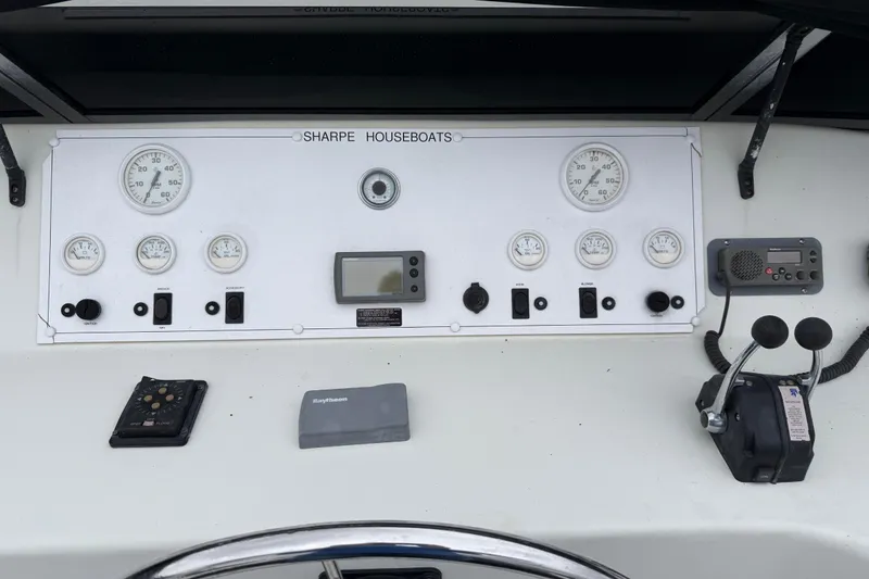 Slide: The Image of Control panel of a 2001 Sharpe 80 X 18 houseboat with gauges and controls. - 135
