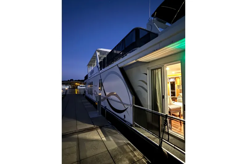 Slide: The Image of Houseboat docked at night, Sharpe 80 X 18, 2001 model, illuminated interior. - 141