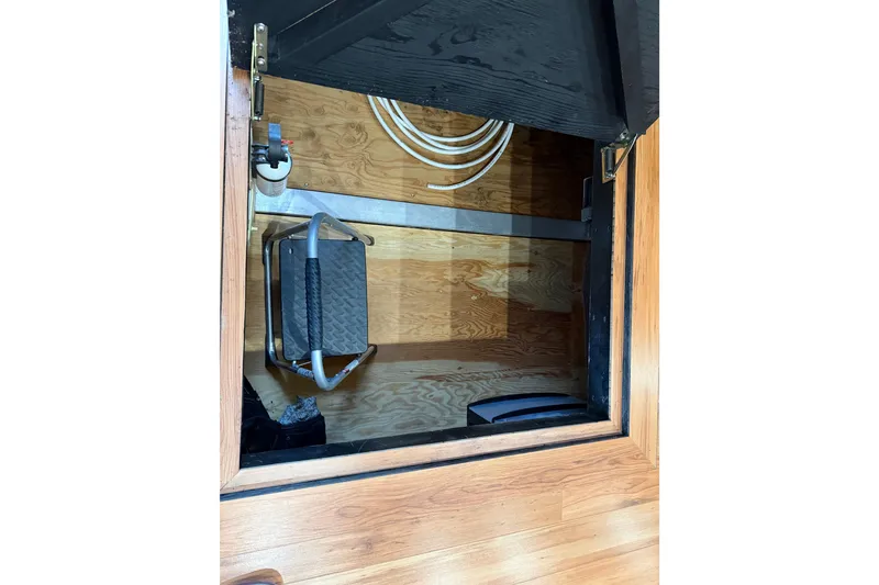 Slide: The Image of Hidden storage compartment in a 2001 Sharpe 80 X 18 boat with wooden flooring. - 19