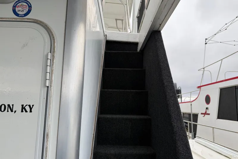 Slide: The Image of Staircase on 2001 Sharpe 80 X 18 houseboat, with visible door and exterior details. - 24