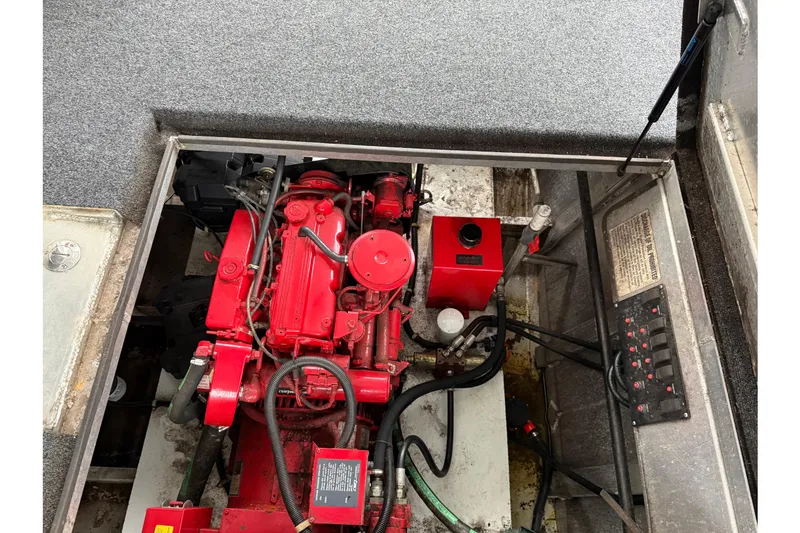 Slide: The Image of Engine compartment of a 2001 Sharpe 80 X 18, featuring a red engine and control panel. - 27