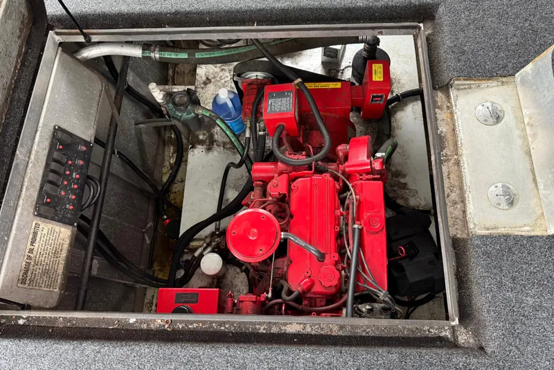 Slide: The Image of Engine compartment of a 2001 Sharpe 80 X 18 houseboat, featuring a red engine. - 28