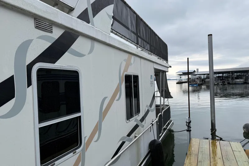 Slide: The Image of Houseboat docked at marina, Sharpe 80 X 18 model, 2001, with decorative exterior design. - 3