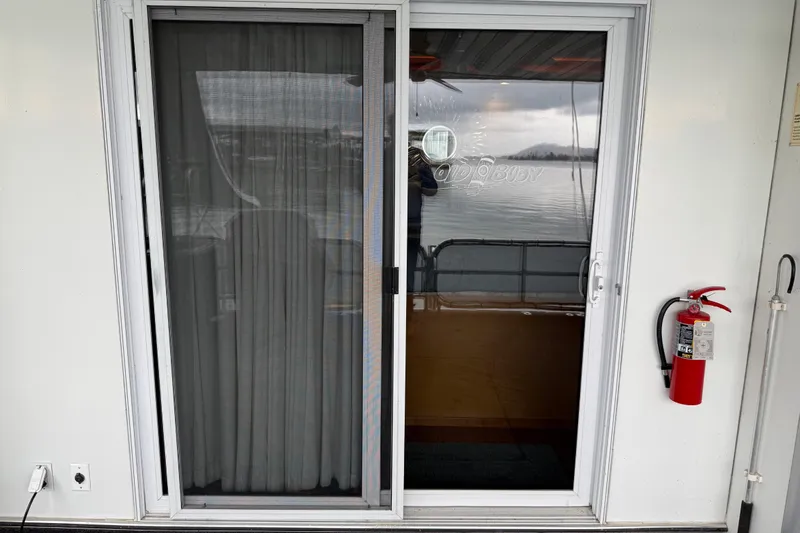 Slide: The Image of Sliding glass door on 2001 Sharpe 80 X 18 houseboat with fire extinguisher nearby. - 30