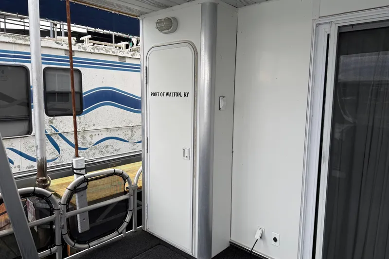 Slide: The Image of Houseboat deck with door labeled "Port of Walton, KY," featuring a Sharpe 80 X 18 model from 2001. - 31