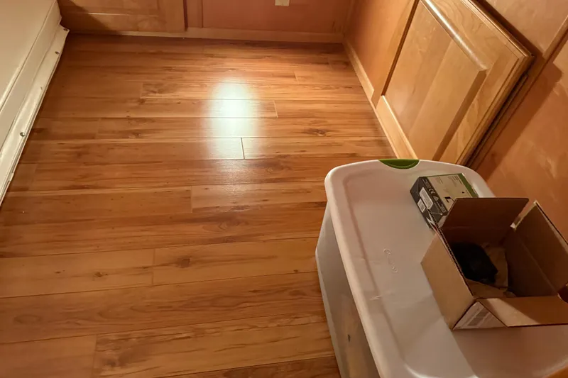 Slide: The Image of Wooden floor with storage boxes in a room, featuring warm lighting. - 43