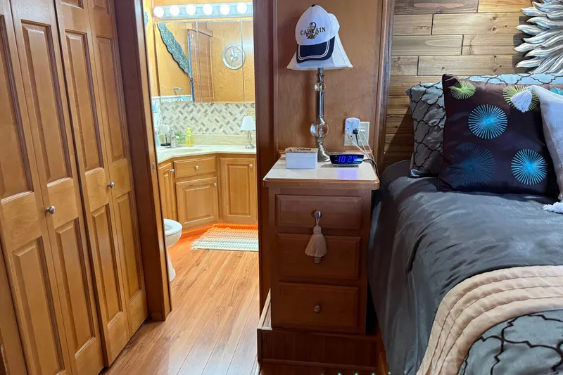 Slide: The Image of Bedroom and bathroom in a 2001 Sharpe 80 X 18 houseboat, featuring wood accents and cozy decor. - 48