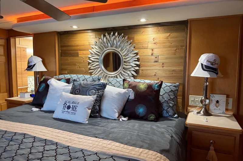 Slide: The Image of Luxurious bedroom with decorative pillows, sunburst mirror, and wooden accents in a 2001 Sharpe 80 X 18. - 54