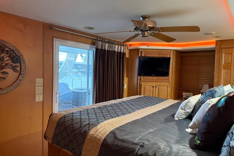 Slide: The Image of Luxurious bedroom interior in 2001 Sharpe 80 X 18 houseboat with modern decor and ceiling fan. - 55