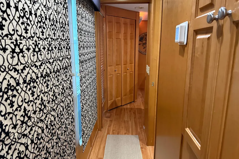 Slide: The Image of Narrow hallway with patterned walls and wooden doors in a 2001 Sharpe 80 X 18. - 61