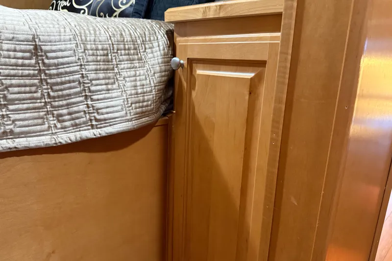 Slide: The Image of Wooden cabinet beside bed with quilted cover, Sharpe 80 X 18, 2001 model. - 63