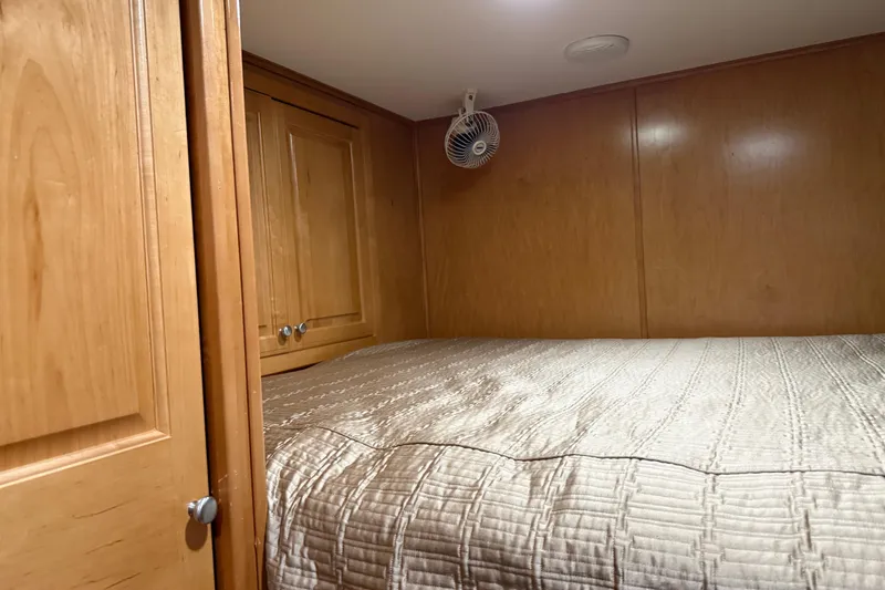 Slide: The Image of Cozy wooden cabin bedroom in 2001 Sharpe 80 X 18 houseboat with fan and storage. - 65