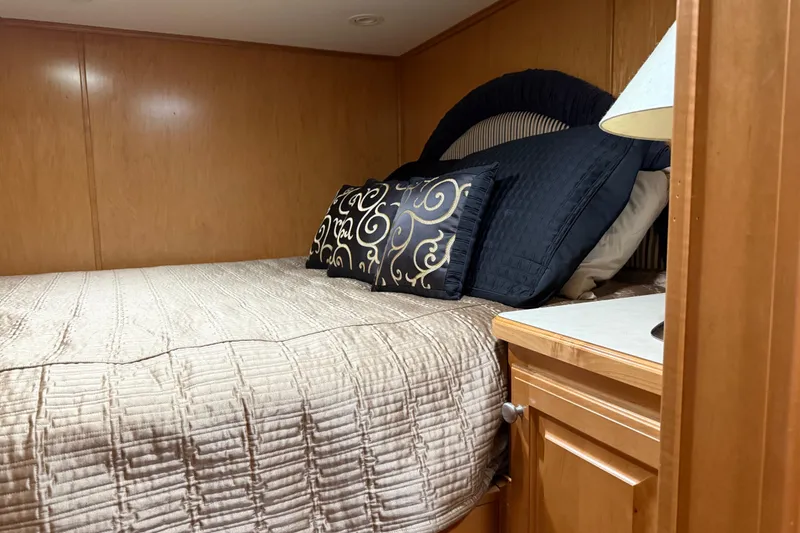 Slide: The Image of Cozy bedroom in 2001 Sharpe 80 X 18 houseboat with elegant pillows and wooden cabinetry. - 66