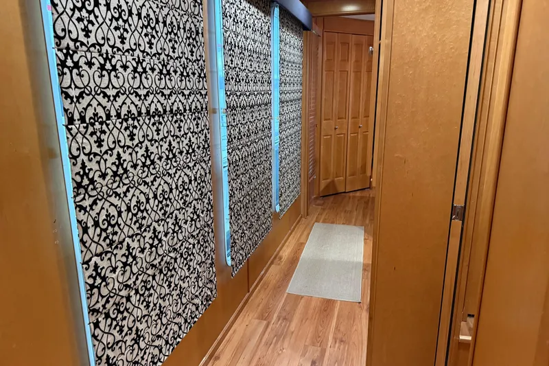 Slide: The Image of Narrow hallway with patterned curtains and wooden flooring in a 2001 Sharpe 80 X 18. - 67