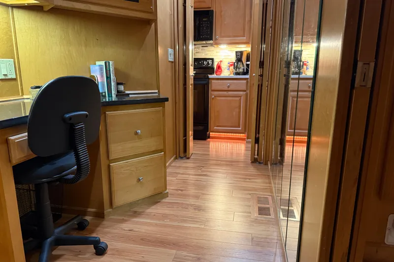 Slide: The Image of Interior of a 2001 Sharpe 80 X 18 houseboat with wooden flooring and kitchen view. - 70