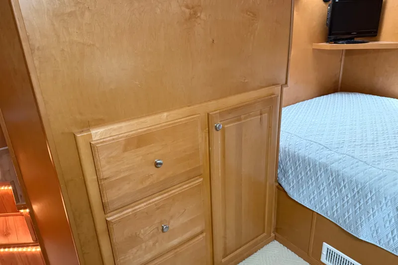 Slide: The Image of Wooden cabinetry and bed in a 2001 Sharpe 80 X 18 houseboat interior. - 71