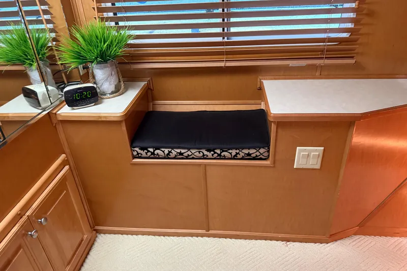 Slide: The Image of Interior of 2001 Sharpe 80 X 18 with wooden cabinetry, clock, and decorative plants. - 74