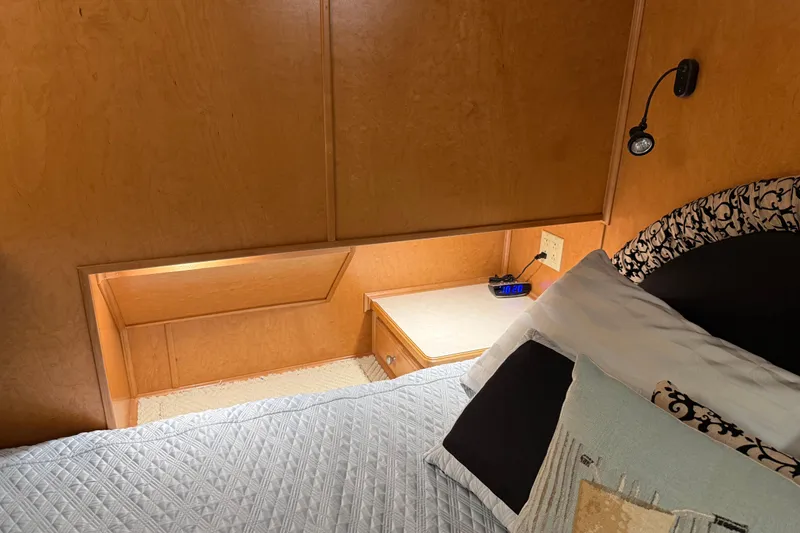 Slide: The Image of Cozy bedroom interior in 2001 Sharpe 80 X 18 houseboat with wood paneling and reading light. - 76