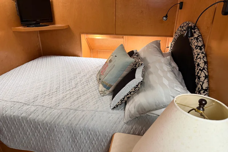 Slide: The Image of Cozy bedroom in 2001 Sharpe 80 X 18 houseboat with elegant bedding and ambient lighting. - 78