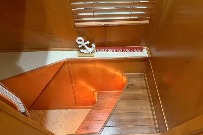 Slide: The Image of Wooden staircase with "Welcome to the Lake" sign, inside 2001 Sharpe 80 X 18 houseboat. - 79